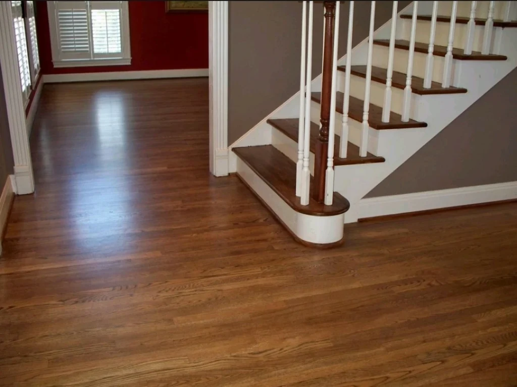 A photo of an Oak Hardwood Floor Refinished With Golden Brown Stain by The Habitat Heroes