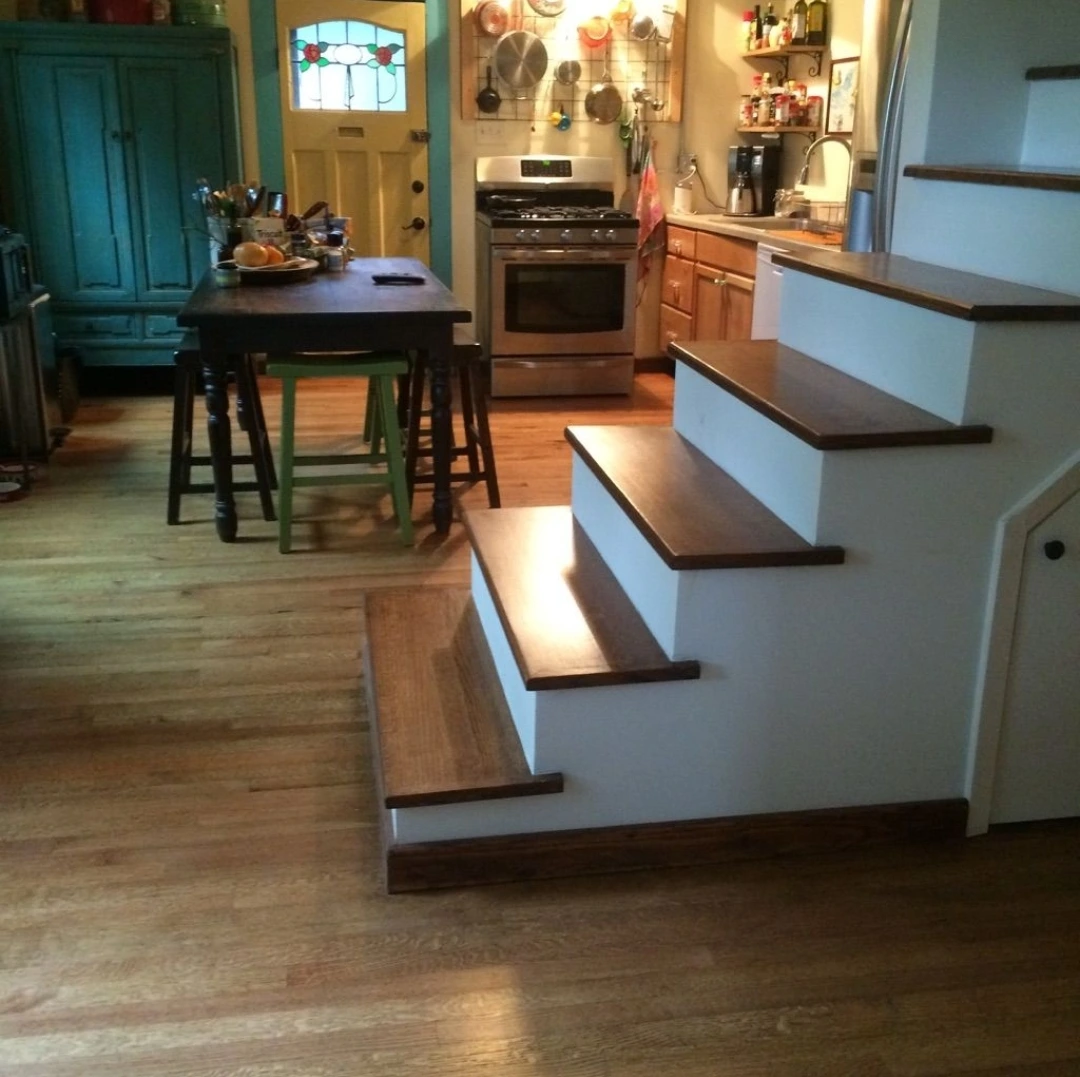 Hardwood floor and stairs installed by Habitat Heroes, an Austin flooring contractor.