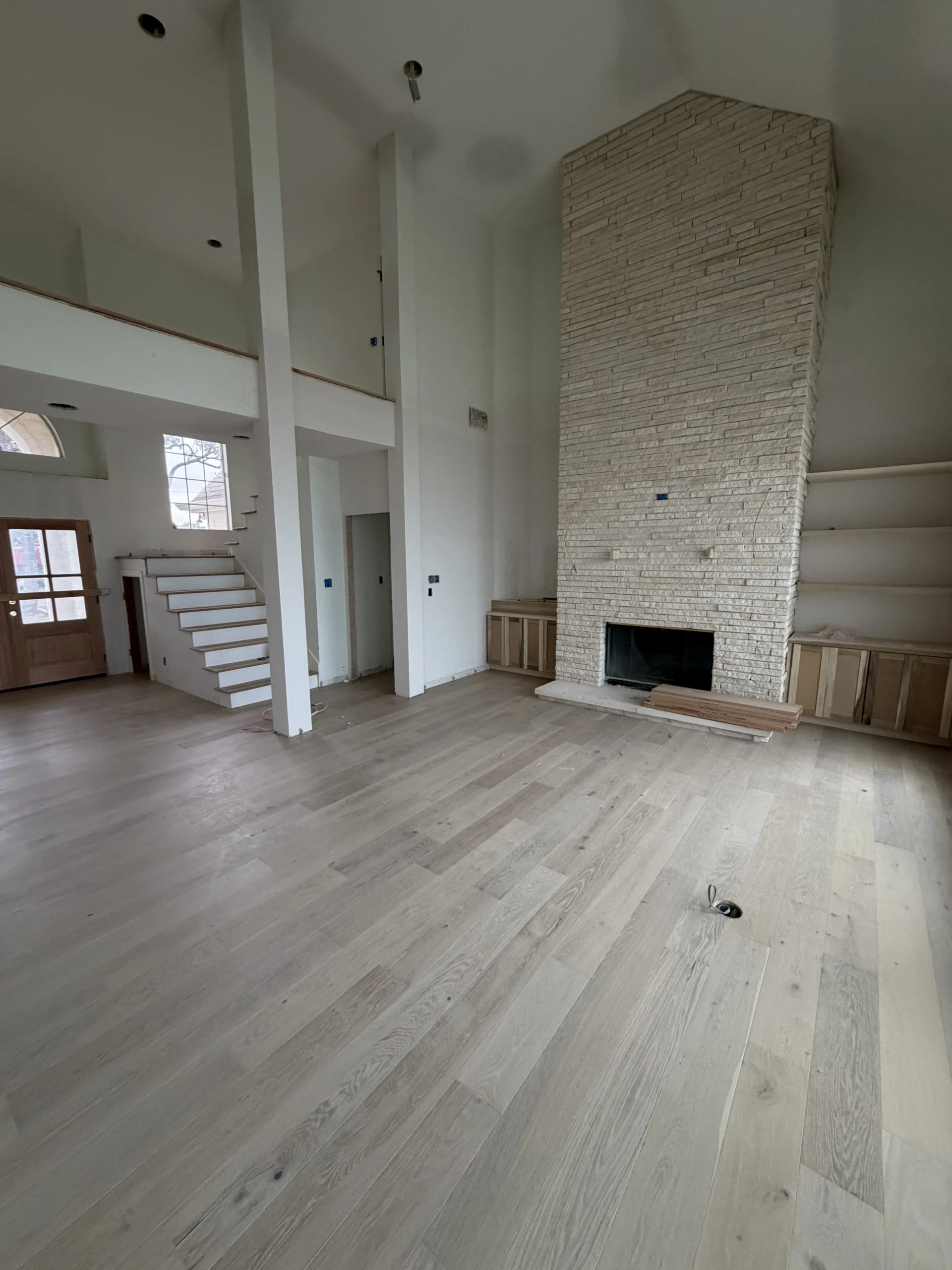 Light greyish brown engineered hardwood flooring installed by Habitat Heroes